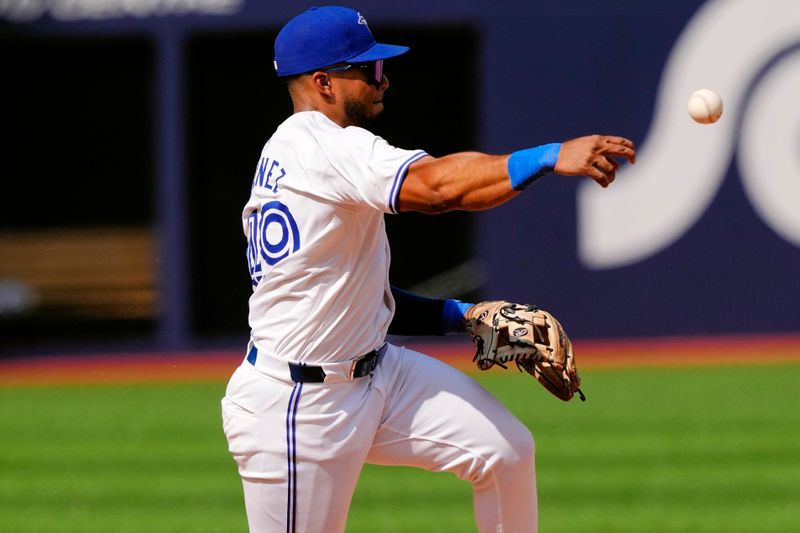 Jul 28, 2024; Toronto, Ontario, CAN; Toronto Blue Jays shortstop Leo Jimenez (49) throws out Texas Rangers center fielder Leody Taveras (not pictured) at first base during the ninth inning at Rogers Centre. Mandatory Credit: John E. Sokolowski-USA TODAY Sports