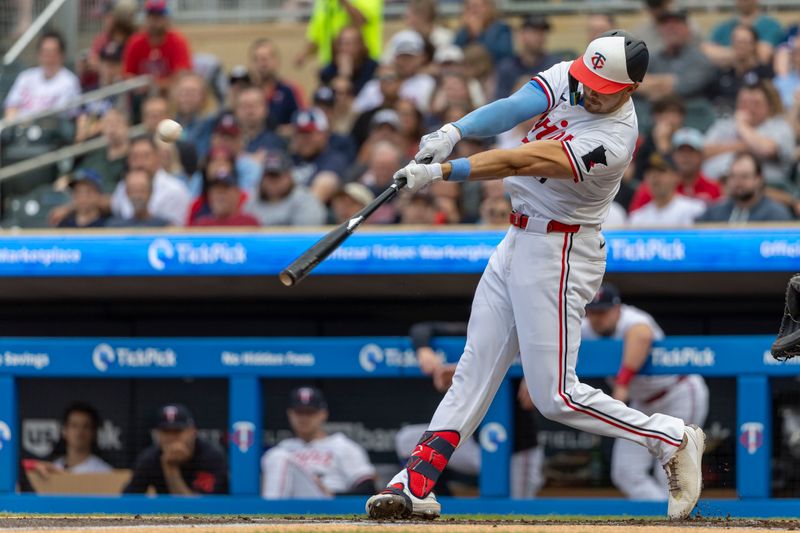 Jun 19, 2024; Minneapolis, Minnesota, USA; Minnesota Twins designated hitter Trevor Larnach (9) hits a double against the Tampa Bay Rays in the first inning at Target Field. Mandatory Credit: Jesse Johnson-USA TODAY Sports