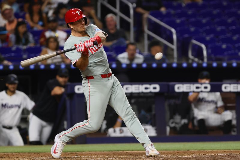 Sep 5, 2024; Miami, Florida, USA; Philadelphia Phillies catcher J.T. Realmuto (10) hits a single against the Miami Marlins during the fourth inning at loanDepot Park. Mandatory Credit: Sam Navarro-Imagn Images