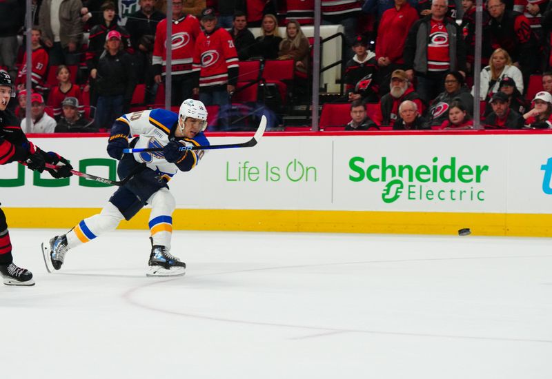 Jan 6, 2024; Raleigh, North Carolina, USA; St. Louis Blues center Brayden Schenn (10) takes a shot against the Carolina Hurricanes during the overtime at PNC Arena. Mandatory Credit: James Guillory-USA TODAY Sports