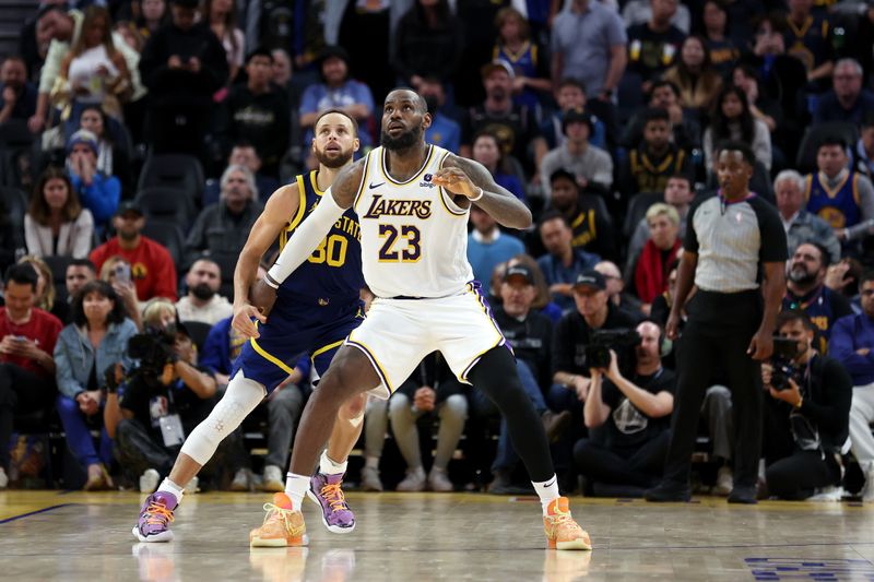 SAN FRANCISCO, CALIFORNIA - JANUARY 27: Stephen Curry #30 of the Golden State Warriors matches up against LeBron James #23 of the Los Angeles Lakers in overtime at Chase Center on January 27, 2024 in San Francisco, California. NOTE TO USER: User expressly acknowledges and agrees that, by downloading and or using this photograph, User is consenting to the terms and conditions of the Getty Images License Agreement.  (Photo by Ezra Shaw/Getty Images)