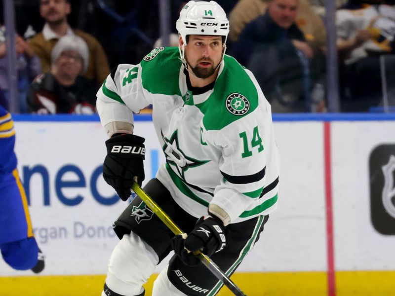 Mar 9, 2023; Buffalo, New York, USA;  Dallas Stars left wing Jamie Benn (14) carries the puck up ice during the first period against the Buffalo Sabres at KeyBank Center. Mandatory Credit: Timothy T. Ludwig-USA TODAY Sports