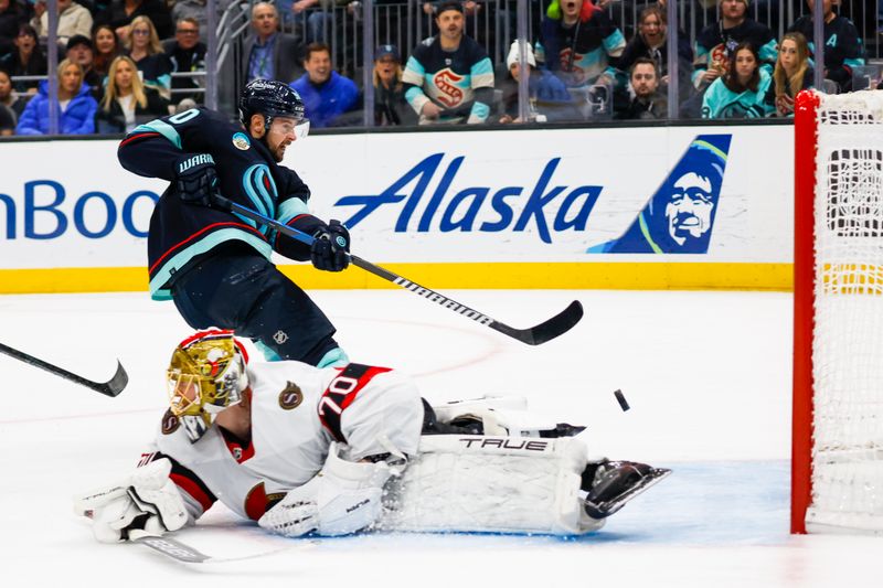 Jan 4, 2024; Seattle, Washington, USA; Seattle Kraken left wing Tomas Tatar (90) scores a goal against Ottawa Senators goaltender Joonas Korpisalo (70) during the second period at Climate Pledge Arena. Mandatory Credit: Joe Nicholson-USA TODAY Sports