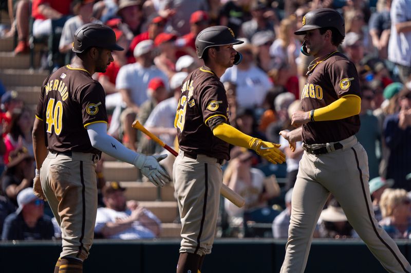 Mar 10, 2024; Tempe, Arizona, USA; San Diego Padres infielder Graham Pauley (80) high-fives with catcher Kyle Higashioka (20) and outfielder Oscar Mercado (40) after scoring in the sixth during a spring training game against the Los Angeles Angels at Tempe Diablo Stadium. Mandatory Credit: Allan Henry-USA TODAY Sports