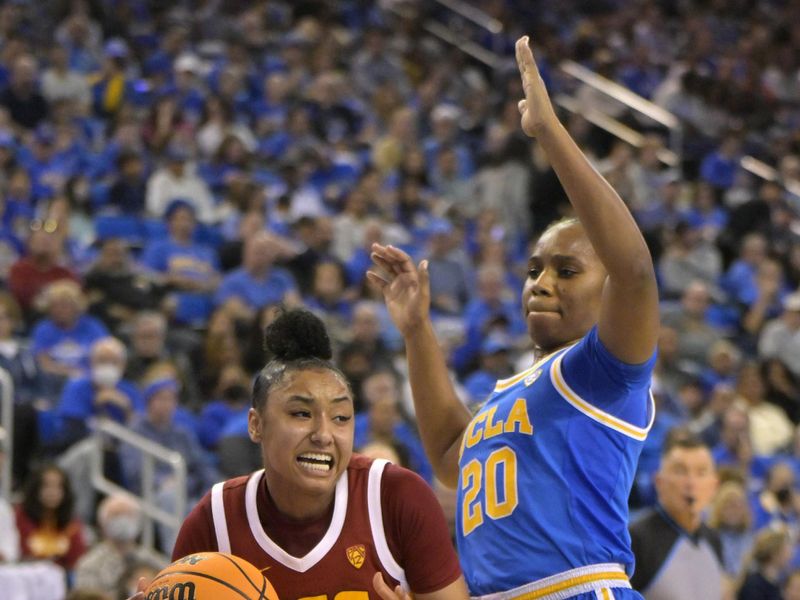 Dec 30, 2023; Los Angeles, California, USA;  USC Trojans guard JuJu Watkins (12) is defended by UCLA Bruins guard Charisma Osborne (20) in the second half at Pauley Pavilion presented by Wescom. Mandatory Credit: Jayne Kamin-Oncea-USA TODAY Sports