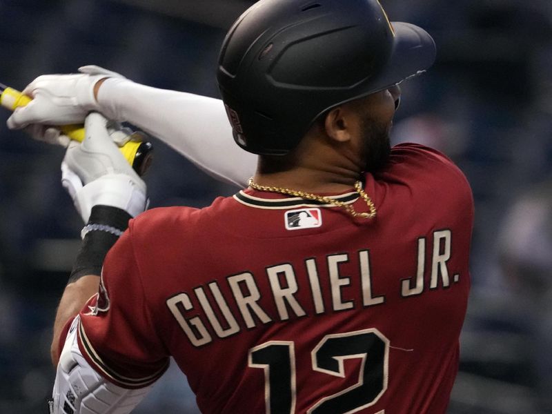 Mar 27, 2023; Phoenix, Arizona, USA; Arizona Diamondbacks left fielder Lourdes Gurriel Jr. (12) bats against the Cleveland Guardians during the first inning at Chase Field. Mandatory Credit: Joe Camporeale-USA TODAY Sports