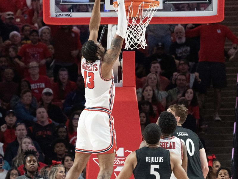 Jan 28, 2023; Houston, Texas, USA; Houston Cougars guard Terrance Arceneaux (23) dunks against Cincinnati Bearcats forward Viktor Lakhin (30) in the second half at Fertitta Center. Houston Cougars won 75 to 69 .Mandatory Credit: Thomas Shea-USA TODAY Sports