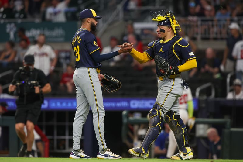 Aug 7, 2024; Atlanta, Georgia, USA; Milwaukee Brewers relief pitcher Devin Williams (38) and catcher William Contreras (24) celebrate after a victory over the Atlanta Braves at Truist Park. Mandatory Credit: Brett Davis-USA TODAY Sports