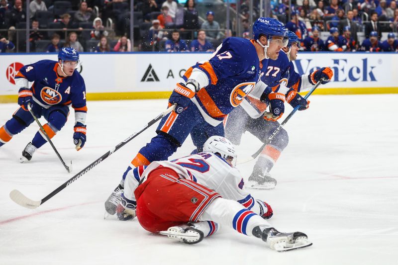 Dec 27, 2025; Elmont, New York, USA;  New York Islanders left wing Anders Lee (27) collides with New York Rangers center Noah Laba (42) in the first period at UBS Arena. Mandatory Credit: Wendell Cruz-Imagn Images