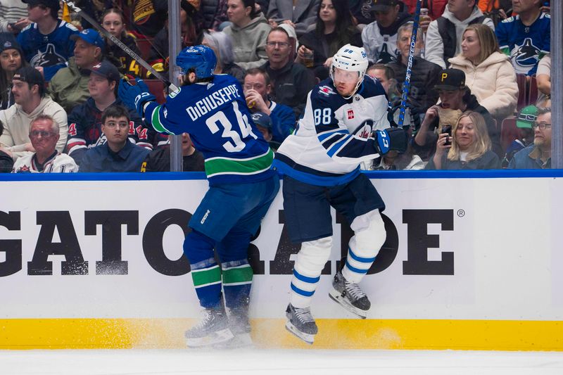 Feb 17, 2024; Vancouver, British Columbia, CAN; Vancouver Canucks forward Phillip Di Giuseppe (34) checks Winnipeg Jets defenseman Nate Schmidt (88) in the second period at Rogers Arena. Mandatory Credit: Bob Frid-USA TODAY Sports