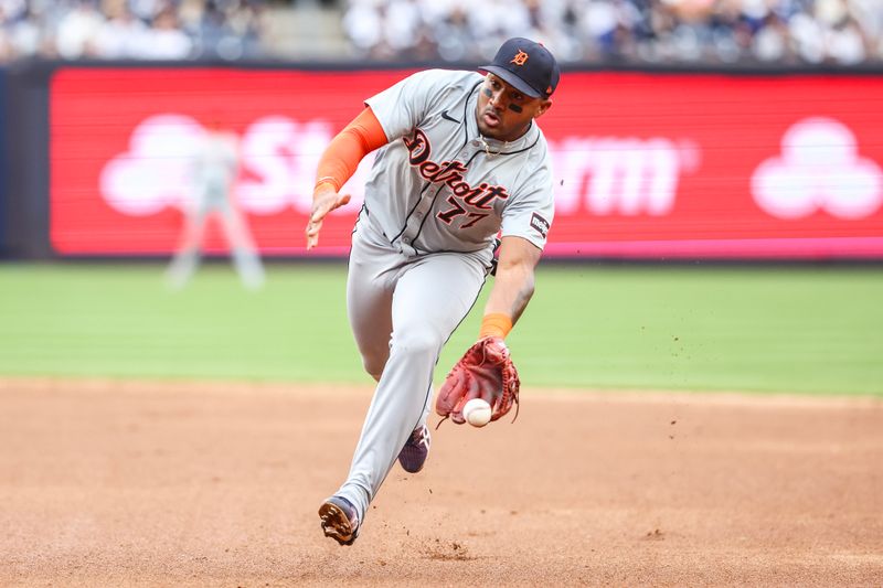 May 4, 2024; Bronx, New York, USA;  Detroit Tigers second base Andy Ibáñez (77) fields a ground ball in the eighth inning against the New York Yankees at Yankee Stadium. Mandatory Credit: Wendell Cruz-USA TODAY Sports