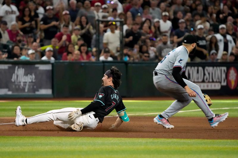 May 26, 2024; Phoenix, Arizona, USA; Arizona Diamondbacks outfielder Corbin Carroll (7) slides into third base after hitting a triple against the Miami Marlins in the eighth inning at Chase Field. Mandatory Credit: Rick Scuteri-USA TODAY Sports