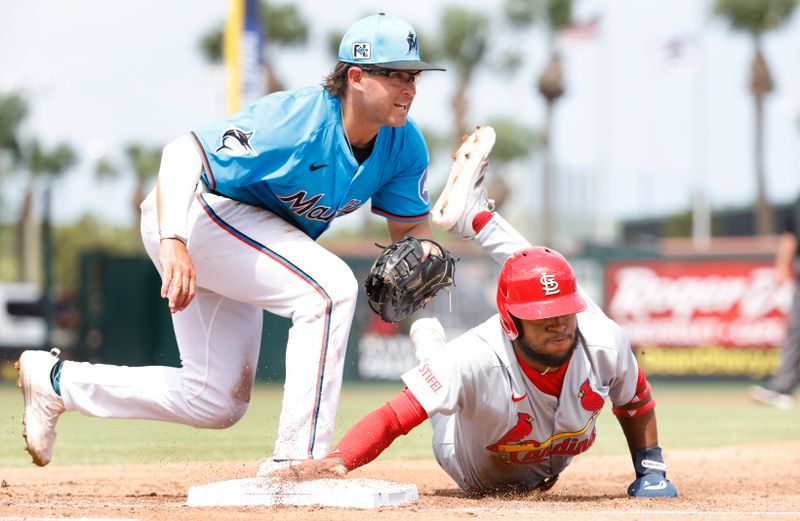 Mar 16, 2025; Jupiter, Florida, USA;  St. Louis Cardinals center fielder Victor Scott II (11) is picked off by Miami Marlins first baseman Jonah Bride (41) during the third inning  at Roger Dean Chevrolet Stadium. Mandatory Credit: Rhona Wise-Imagn Images