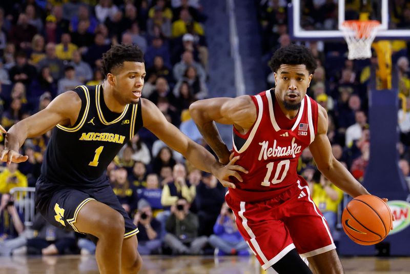 Jan 27, 2026; Ann Arbor, Michigan, USA;  Michigan Wolverines guard Winters Grady (10) dribbles defended by Michigan Wolverines guard Trey McKenney (1) in the second half at Crisler Center. Mandatory Credit: Rick Osentoski-Imagn Images