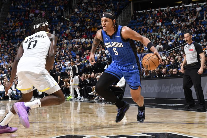 ORLANDO, FL - FEBRUARY 29: Paolo Banchero #5 of the Orlando Magic handles the ball during the game against the Utah Jazz on February 29, 2024 at Amway Center in Orlando, Florida. NOTE TO USER: User expressly acknowledges and agrees that, by downloading and or using this photograph, User is consenting to the terms and conditions of the Getty Images License Agreement. Mandatory Copyright Notice: Copyright 2024 NBAE (Photo by Fernando Medina/NBAE via Getty Images)