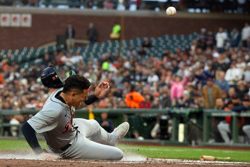 Aug 9, 2024; San Francisco, California, USA; Detroit Tigers third baseman Gio Urshela (13) reacts to being hit by an errant relay as he scores on a sacrifice fly against the San Francisco Giants during the second inning at Oracle Park. Mandatory Credit: D. Ross Cameron-USA TODAY Sports