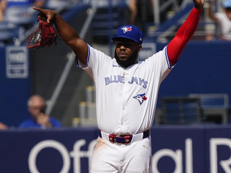 Jul 28, 2024; Toronto, Ontario, CAN; Toronto Blue Jays first baseman Vladimir Guerrero Jr. (27) signals to his teammates during the ninth inning against the Texas Rangers at Rogers Centre. Mandatory Credit: John E. Sokolowski-USA TODAY Sports