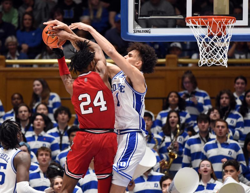 Feb 20, 2023; Durham, North Carolina, USA; Duke Blue Devils center Dereck Lively (1) ties up Louisville Cardinals forward Jae'Lyn Withers (24) during the second half at Cameron Indoor Stadium. The Blue Devils won 79-62. Mandatory Credit: Rob Kinnan-USA TODAY Sports