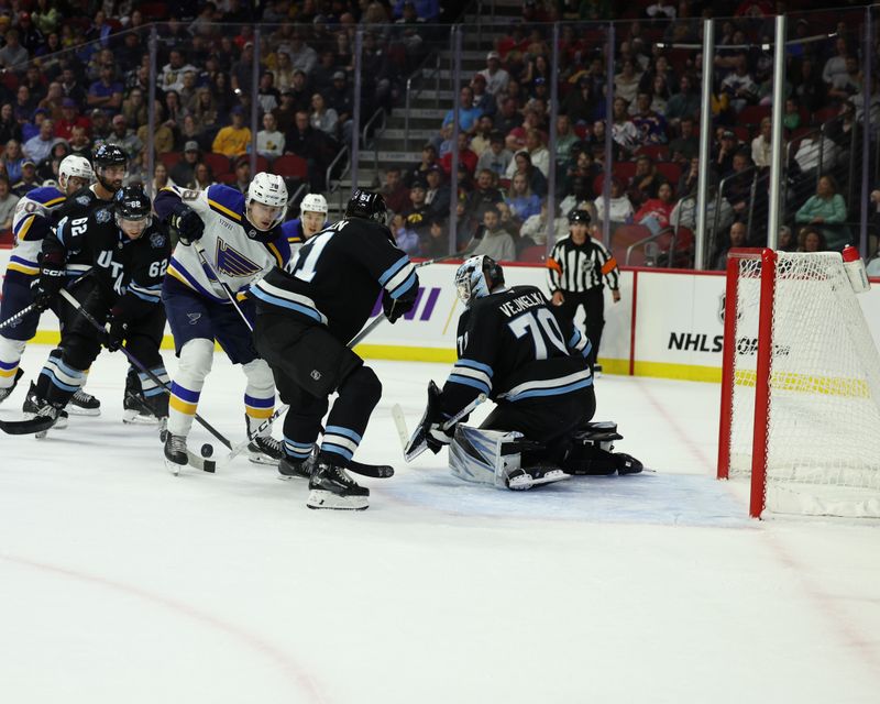 Sep 22, 2024; Des Moines, Iowa, USA; St. Louis Blues center Tanner Dickinson (78) shoots against Utah Hockey Club goaltender Karel Vejmelka (70) at Wells Fargo Arena. Mandatory Credit: Reese Strickland-Imagn Images

