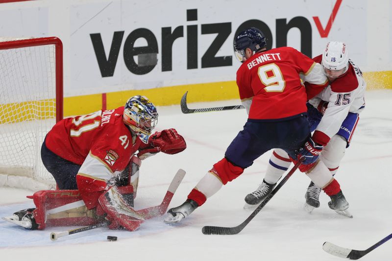 Feb 29, 2024; Sunrise, Florida, USA; Montreal Canadiens center Alex Newhook (15) attempts to reach for the puck as Florida Panthers center Sam Bennett (9) and goaltender Anthony Stolarz (41) defend during overtime at Amerant Bank Arena. Mandatory Credit: Sam Navarro-USA TODAY Sports