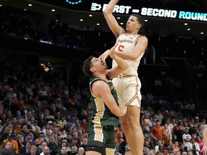 Mar 21, 2024; Charlotte, NC, USA; Texas Longhorns forward Kadin Shedrick (5) takes a shot while defended by Colorado State Rams forward Joel Scott (1) in the first half of the first round of the 2024 NCAA Tournament at Spectrum Center. Mandatory Credit: Jim Dedmon-USA TODAY Sports