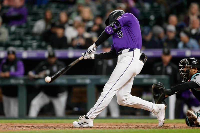 Apr 8, 2024; Denver, Colorado, USA; Colorado Rockies center fielder Brenton Doyle (9) hits a double in the sixth inning against the Arizona Diamondbacks at Coors Field. Mandatory Credit: Isaiah J. Downing-USA TODAY Sports