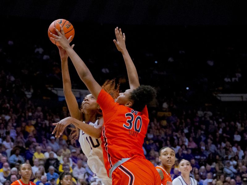 Feb 22, 2024; Baton Rouge, Louisiana, USA;  LSU Lady Tigers forward Angel Reese (10) has her shot blocked by Auburn Tigers center Savannah Scott (30) during the first half at Pete Maravich Assembly Center. Mandatory Credit: Matthew Hinton-USA TODAY Sports