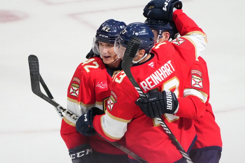 Oct 19, 2024; Sunrise, Florida, USA;  Florida Panthers defenseman Gustav Forsling (42) celebrates with Sam Bennett (9) and Sam Reinhart (13) after a goal against the Vegas Golden Knights during overtime at Amerant Bank Arena. Mandatory Credit: Jim Rassol-Imagn Images