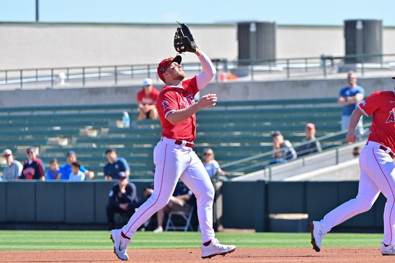 Feb 29, 2024; Tempe, Arizona, USA;  Los Angeles Angels second baseman Brandon Drury (23) catches a fly ball in the second inning against the Cleveland Guardians during a spring training game at Tempe Diablo Stadium. Mandatory Credit: Matt Kartozian-USA TODAY Sports