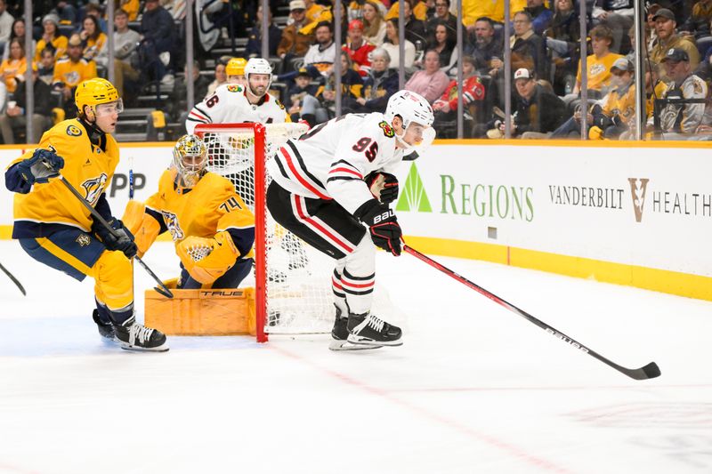 Jan 16, 2025; Nashville, Tennessee, USA;  Chicago Blackhawks center Connor Bedard (98) skates behind the net against the Nashville Predators during the second period at Bridgestone Arena. Mandatory Credit: Steve Roberts-Imagn Images