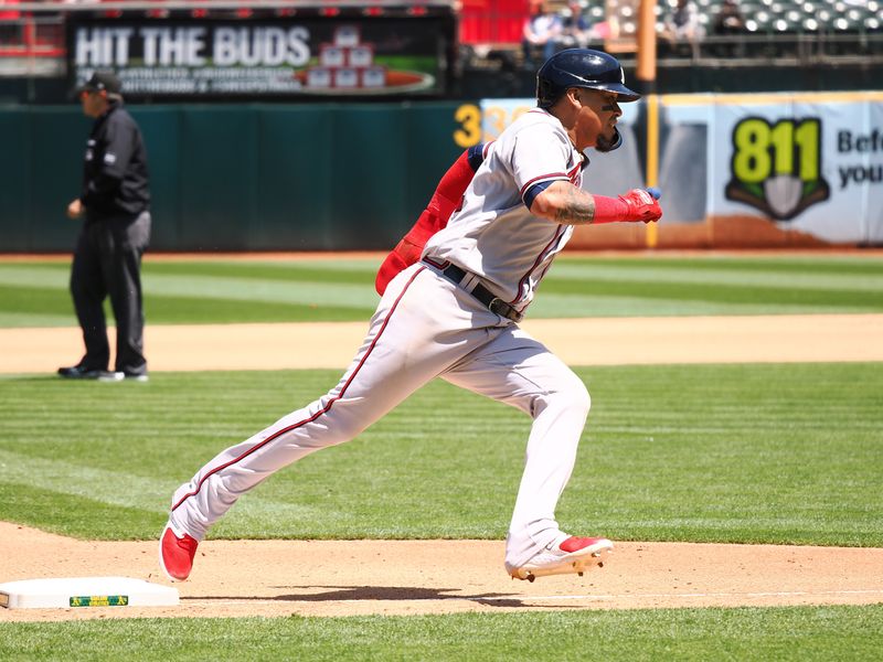 May 31, 2023; Oakland, California, USA; Atlanta Braves shortstop Orlando Arcia (11) rounds third base to score a run against the Oakland Athletics during the seventh inning at Oakland-Alameda County Coliseum. Mandatory Credit: Kelley L Cox-USA TODAY Sports