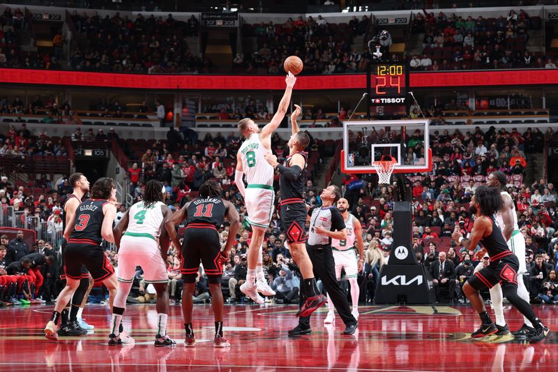 CHICAGO, IL - NOVEMBER 29: Kristaps Porzingis #8 of the Boston Celtics and Nikola Vucevic #9 of the Chicago Bulls go for the opening tip-off during the Emirates NBA Cup game on November 29, 2024 at United Center in Chicago, Illinois. NOTE TO USER: User expressly acknowledges and agrees that, by downloading and or using this photograph, User is consenting to the terms and conditions of the Getty Images License Agreement. Mandatory Copyright Notice: Copyright 2024 NBAE (Photo by Jeff Haynes/NBAE via Getty Images)