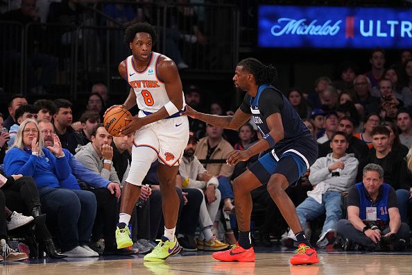 NEW YORK, NEW YORK - JANUARY 1: OG Anunoby #8 of the New York Knicks controls the ball against Naz Reid #11 of the Minnesota Timberwolves in the first half at Madison Square Garden on January 1, 2024 in New York City. NOTE TO USER: User expressly acknowledges and agrees that, by downloading and or using this photograph, User is consenting to the terms and conditions of the Getty Images License Agreement. (Photo by Mitchell Leff/Getty Images)