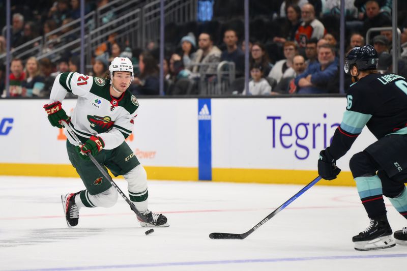 Dec 10, 2023; Seattle, Washington, USA; Minnesota Wild right wing Brandon Duhaime (21) advances the puck against the Seattle Kraken during the first period at Climate Pledge Arena. Mandatory Credit: Steven Bisig-USA TODAY Sports