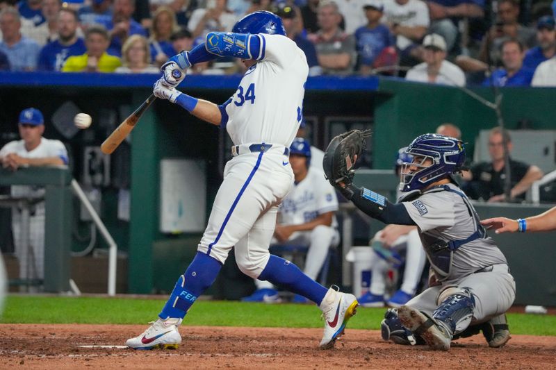 Jun 10, 2024; Kansas City, Missouri, USA; Kansas City Royals catcher Freddy Fermin (34) hits a one-run single against the New York Yankees in the eighth inning at Kauffman Stadium. Mandatory Credit: Denny Medley-USA TODAY Sports