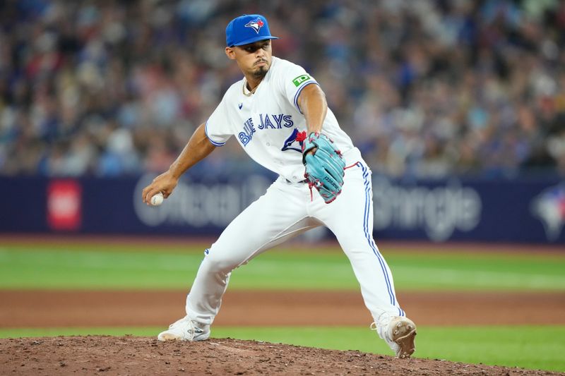 Aug 15, 2023; Toronto, Ontario, CAN; Toronto Blue Jays pitcher Jordan Hicks (12) pitches against the Philadelphia Phillies during the eighth inning at Rogers Centre. Mandatory Credit: John E. Sokolowski-USA TODAY Sports