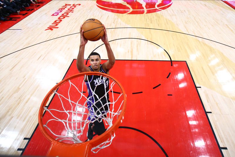 TORONTO, CANADA - MARCH 20: Keegan Murray #13 of the Sacramento Kings dunks the ball during the game against the Toronto Raptors on March 20, 2024 at the Scotiabank Arena in Toronto, Ontario, Canada.  NOTE TO USER: User expressly acknowledges and agrees that, by downloading and or using this Photograph, user is consenting to the terms and conditions of the Getty Images License Agreement.  Mandatory Copyright Notice: Copyright 2024 NBAE (Photo by Vaughn Ridley/NBAE via Getty Images)