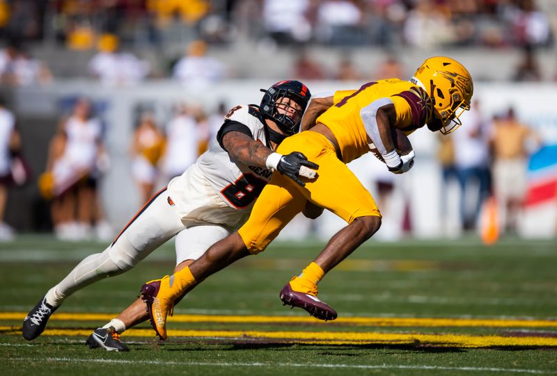 Nov 19, 2022; Tempe, Arizona, USA; Oregon State Beavers linebacker Kyrei Fisher-Morris (8) tackles Arizona State Sun Devils running back Xazavian Valladay (1) at Sun Devil Stadium. Mandatory Credit: Mark J. Rebilas-USA TODAY Sports