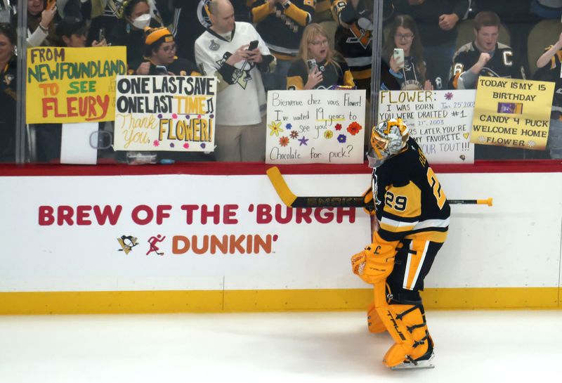 Sep 27, 2025; Pittsburgh, Pennsylvania, USA;  Pittsburgh Penguins goaltender Marc-Andre Fleury (29) skates past fans holding signs during warm ups before the game against the Columbus Blue Jackets at PPG Paints Arena. Mandatory Credit: Charles LeClaire-Imagn Images