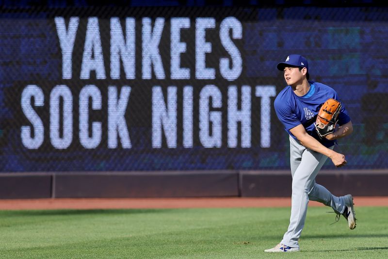 Jun 7, 2024; Bronx, New York, USA; Los Angeles Dodgers designated hitter Shohei Ohtani (17) throws in the outfield before a game against the New York Yankees at Yankee Stadium. Mandatory Credit: Brad Penner-USA TODAY Sports