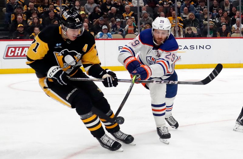 Mar 10, 2024; Pittsburgh, Pennsylvania, USA;  Pittsburgh Penguins center Evgeni Malkin (71) and Edmonton Oilers center Leon Draisaitl (29) chase the puck during the second period at PPG Paints Arena. Mandatory Credit: Charles LeClaire-USA TODAY Sports