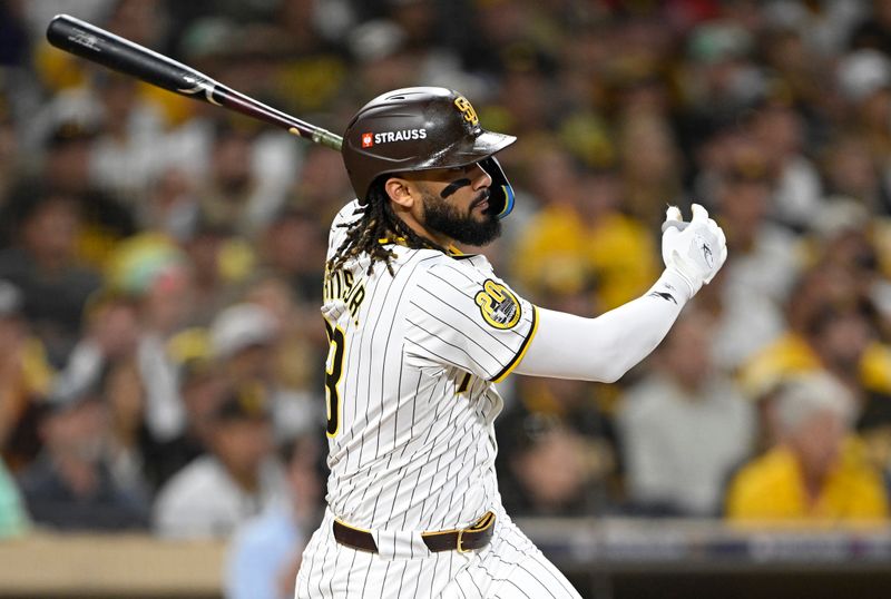 Oct 2, 2024; San Diego, California, USA; San Diego Padres outfielder Fernando Tatis Jr. (23) singles during the fourth inning of game two in the Wildcard round for the 2024 MLB Playoffs against the Atlanta Braves at Petco Park. Mandatory Credit: Denis Poroy-Imagn Images