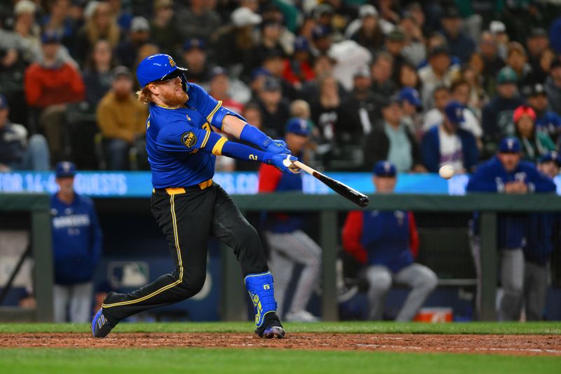 Sep 14, 2024; Seattle, Washington, USA; Seattle Mariners first baseman Justin Turner (2) hits a double against the Texas Rangers during the eighth inning at T-Mobile Park. Mandatory Credit: Steven Bisig-Imagn Images