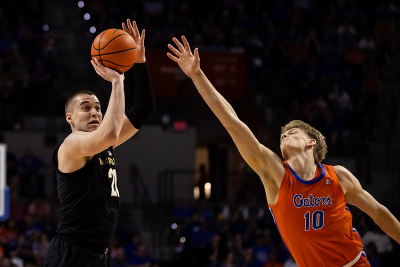 Feb 24, 2024; Gainesville, Florida, USA; Florida Gators forward Thomas Haugh (10) attempts to block a shot from Vanderbilt Commodores forward Tasos Kamateros (21) during the first half at Exactech Arena at the Stephen C. O'Connell Center. Mandatory Credit: Matt Pendleton-USA TODAY Sports