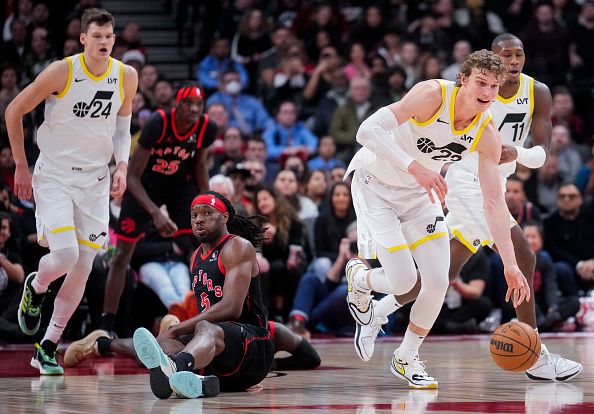 TORONTO, ON - DECEMBER 23: Lauri Markkanen #23 of the Utah Jazz dribbles past Precious Achiuwa #5 of the Toronto Raptors during the second half of their basketball game at the Scotiabank Arena on December 23, 2023 in Toronto, Ontario, Canada. NOTE TO USER: User expressly acknowledges and agrees that, by downloading and/or using this Photograph, user is consenting to the terms and conditions of the Getty Images License Agreement. (Photo by Mark Blinch/Getty Images)