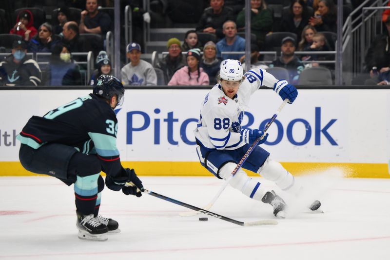 Jan 21, 2024; Seattle, Washington, USA; Toronto Maple Leafs right wing William Nylander (88) plays the puck while defended by Seattle Kraken defenseman Ryker Evans (39) during the first period at Climate Pledge Arena. Mandatory Credit: Steven Bisig-USA TODAY Sports