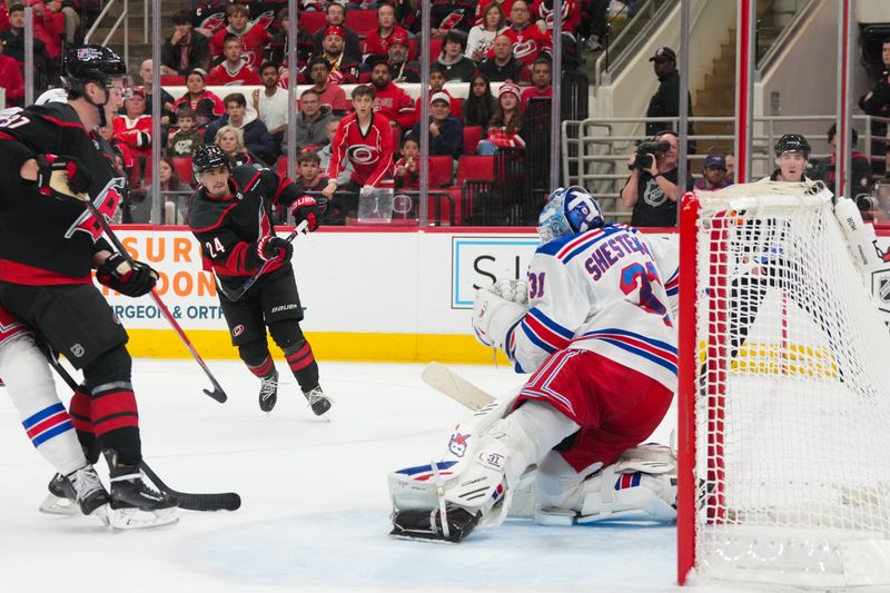 Nov 26, 2025; Raleigh, North Carolina, USA; Carolina Hurricanes center Seth Jarvis (24) scores a goal past New York Rangers goaltender Igor Shesterkin (31) during the third period at Lenovo Center. Mandatory Credit: James Guillory-Imagn Images