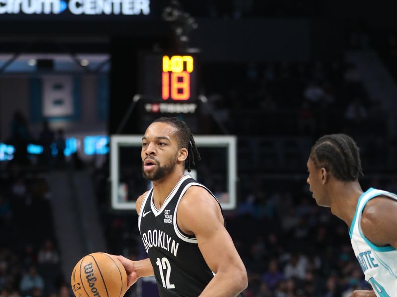 CHARLOTTE, NC - JANUARY 29: Tosan Evbuomwan #12 of the Brooklyn Nets dribbles the ball during the gameagainst the Charlotte Hornets on January 29, 2025 at Spectrum Center in Charlotte, North Carolina. NOTE TO USER: User expressly acknowledges and agrees that, by downloading and or using this photograph, User is consenting to the terms and conditions of the Getty Images License Agreement. Mandatory Copyright Notice: Copyright 2025 NBAE (Photo by Brock Williams-Smith/NBAE via Getty Images)