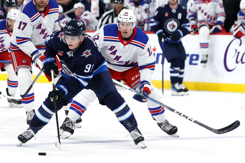 Oct 30, 2023; Winnipeg, Manitoba, CAN; Winnipeg Jets center Cole Perfetti (91) is chased down by New York Rangers center Nick Bonino (12) in the second period at Canada Life Centre. Mandatory Credit: James Carey Lauder-USA TODAY Sports