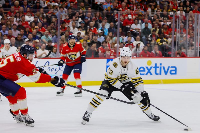 May 14, 2024; Sunrise, Florida, USA; Boston Bruins center Danton Heinen (43) moves the puck as Florida Panthers defenseman Aaron Ekblad (5) defends during the first period in game five of the second round of the 2024 Stanley Cup Playoffs at Amerant Bank Arena. Mandatory Credit: Sam Navarro-USA TODAY Sports